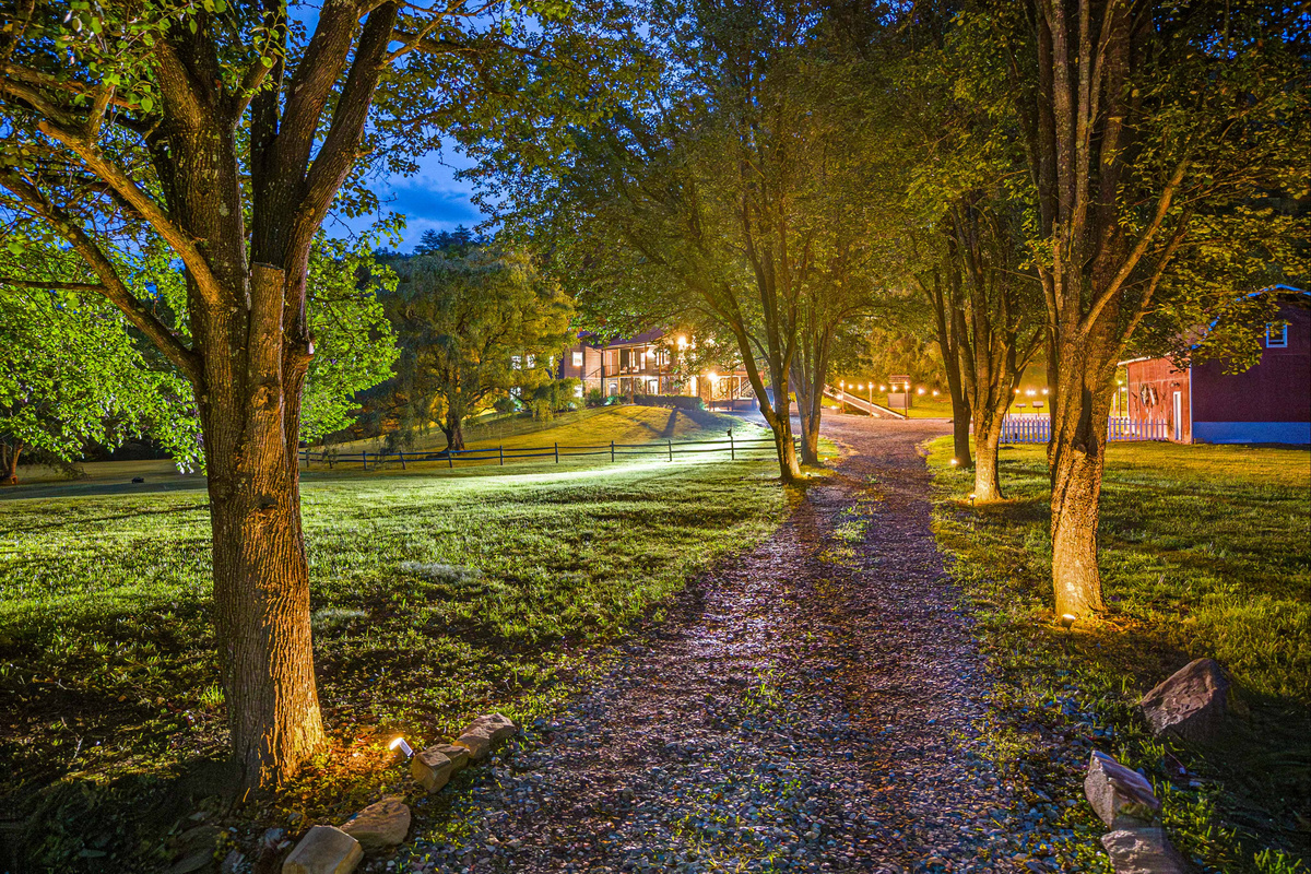 Exterior: Stroll the enchanting path lined with trees, leading to your tranquil retreat!