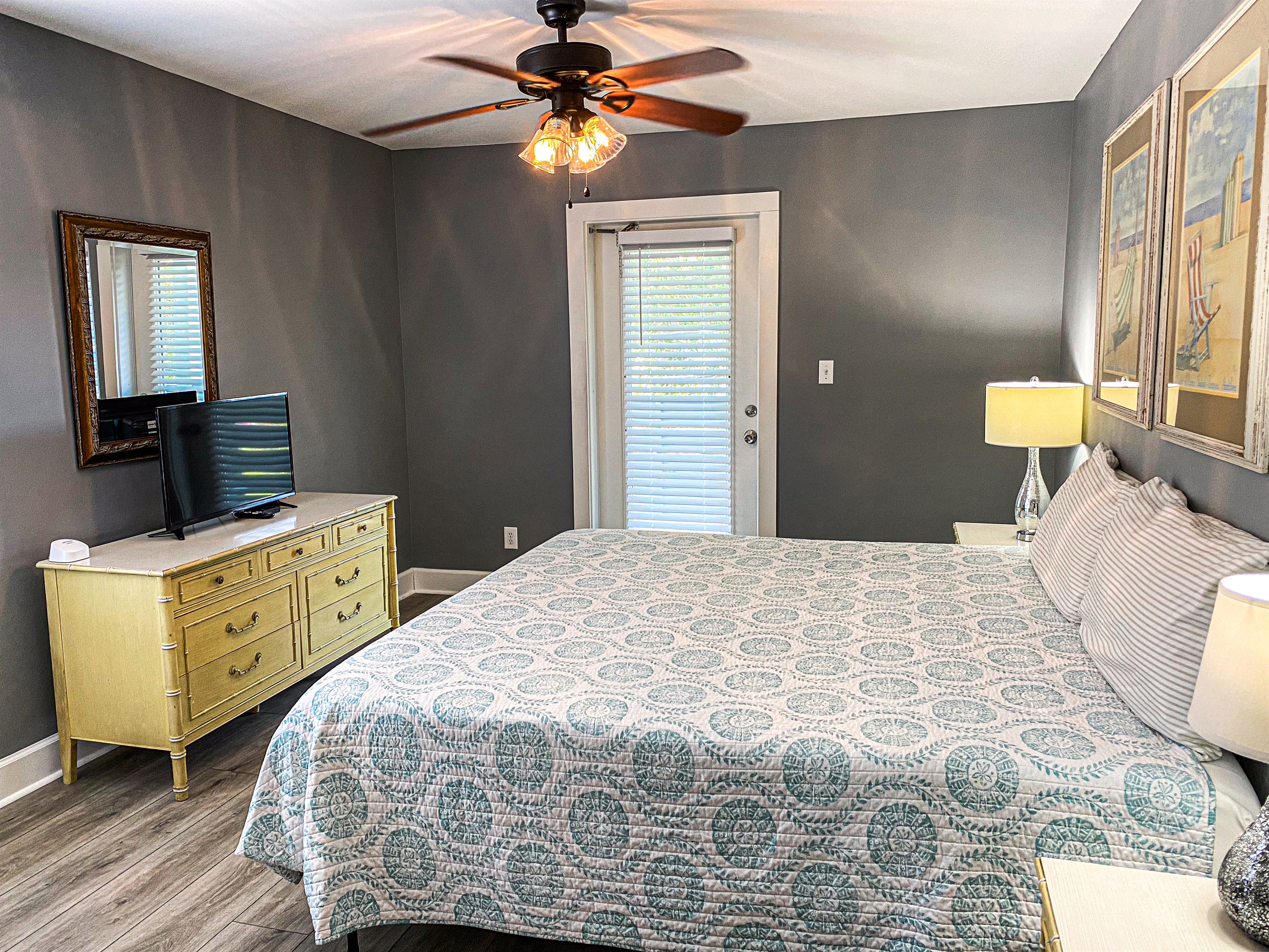 Bedroom 5 of 6 with king bed, attached bath, and door to the balcony with seating