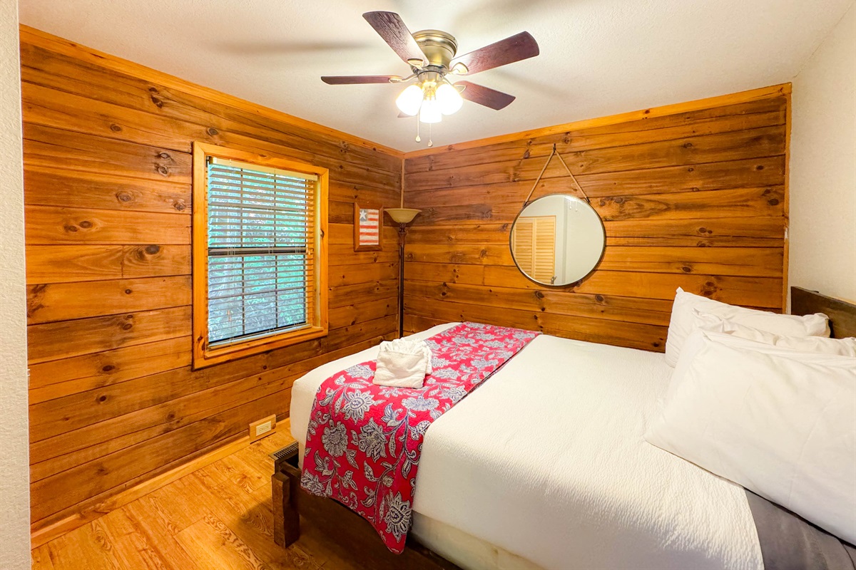 Main level bedroom featuring a queen bed