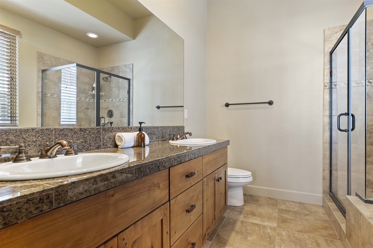 A spacious, ensuite bathroom with double sinks and a walk-in shower—ideal for getting ready with ease.