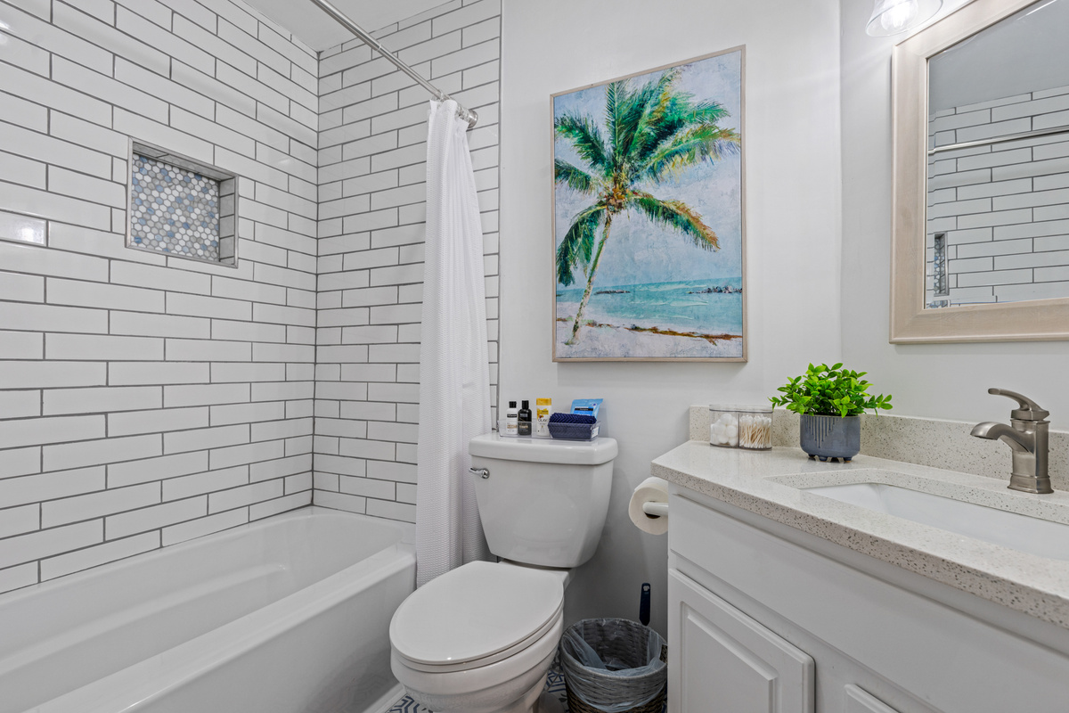 Guest bathroom with custom tiled shower/tub combo.