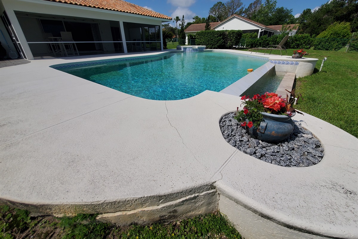View of pool deck, pool and spa; oversized lanai