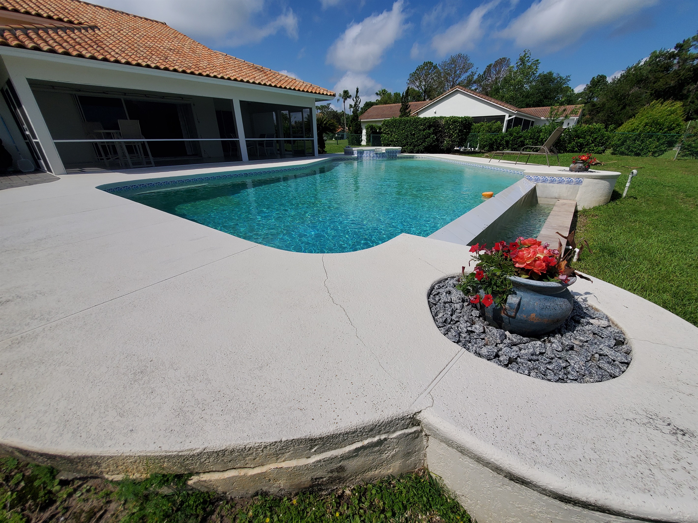 View of pool deck, pool and spa; oversized lanai