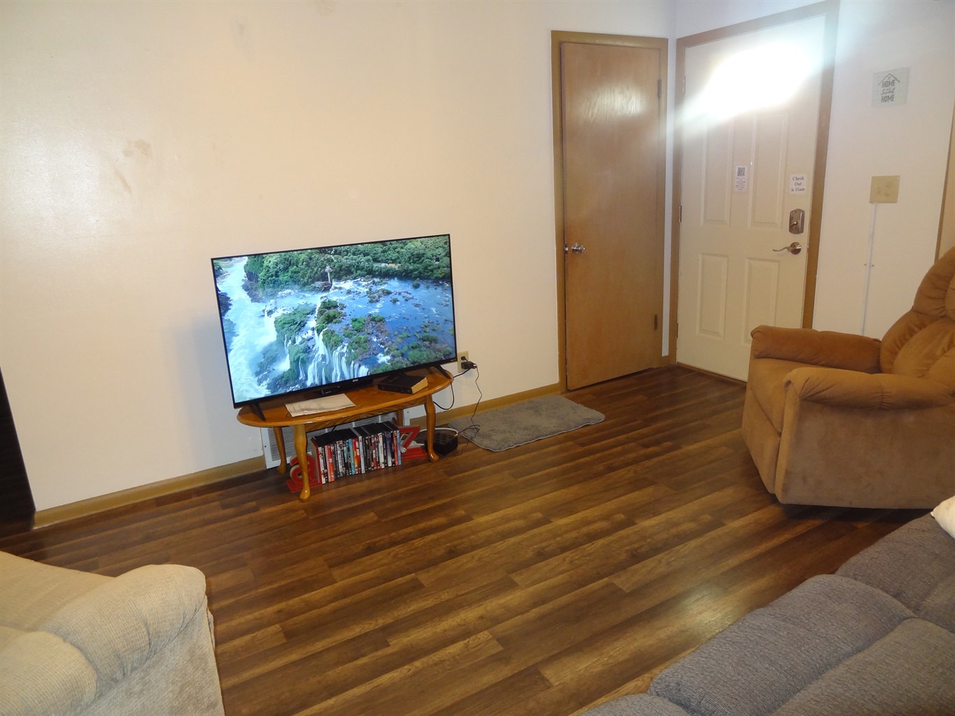 Living room with 2 recliners, reclining couch and Roku smart TV