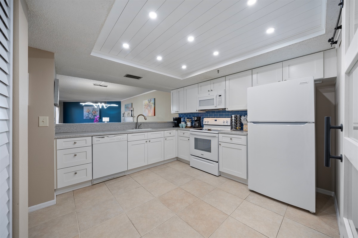 Fully stocked custom kitchen open to the living room.