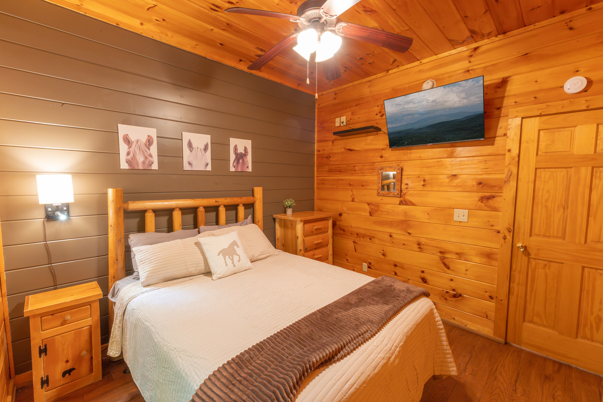 With a smart TV and ensuite bathroom, our "horse" queen bedroom is another perfect bedroom on the lower level!