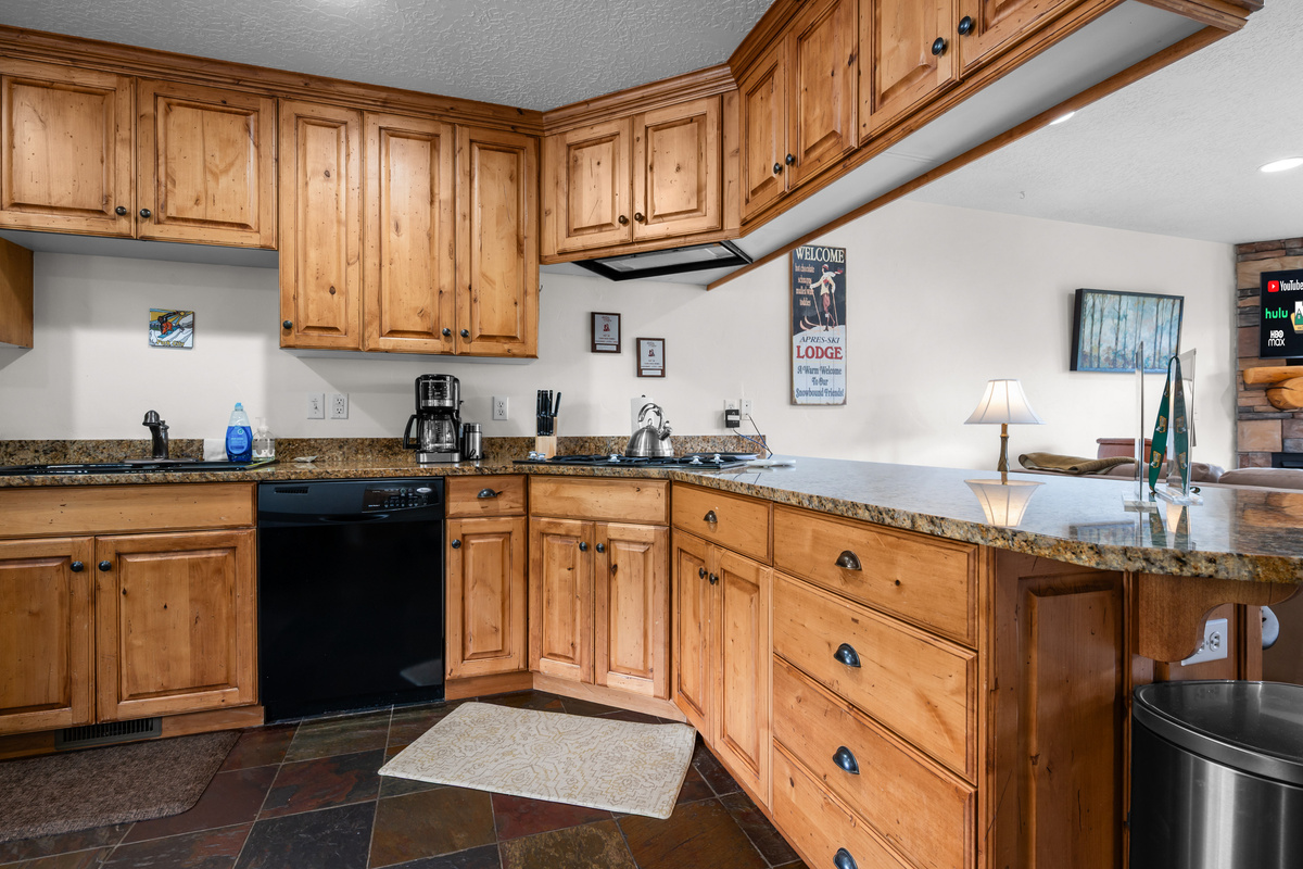 The fully equipped kitchen offers ample counter space, rustic cabinetry, and everything needed for easy meals after a day of adventure.