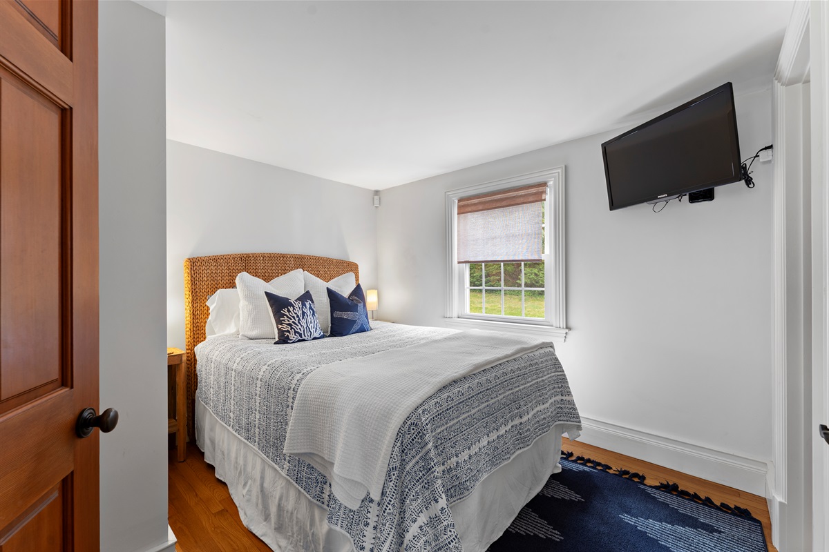 A luxurious master suite with a queen bed and private half bathroom, your perfect escape.
