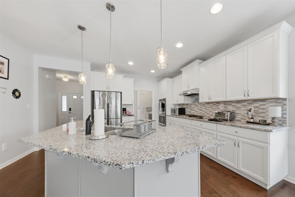 Stainless steel appliances, granite countertops and real wood cabinets