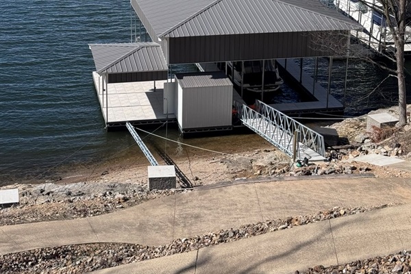 Brand new concrete dock (March 2026) with covered boat slip 10'x32' and swim deck.