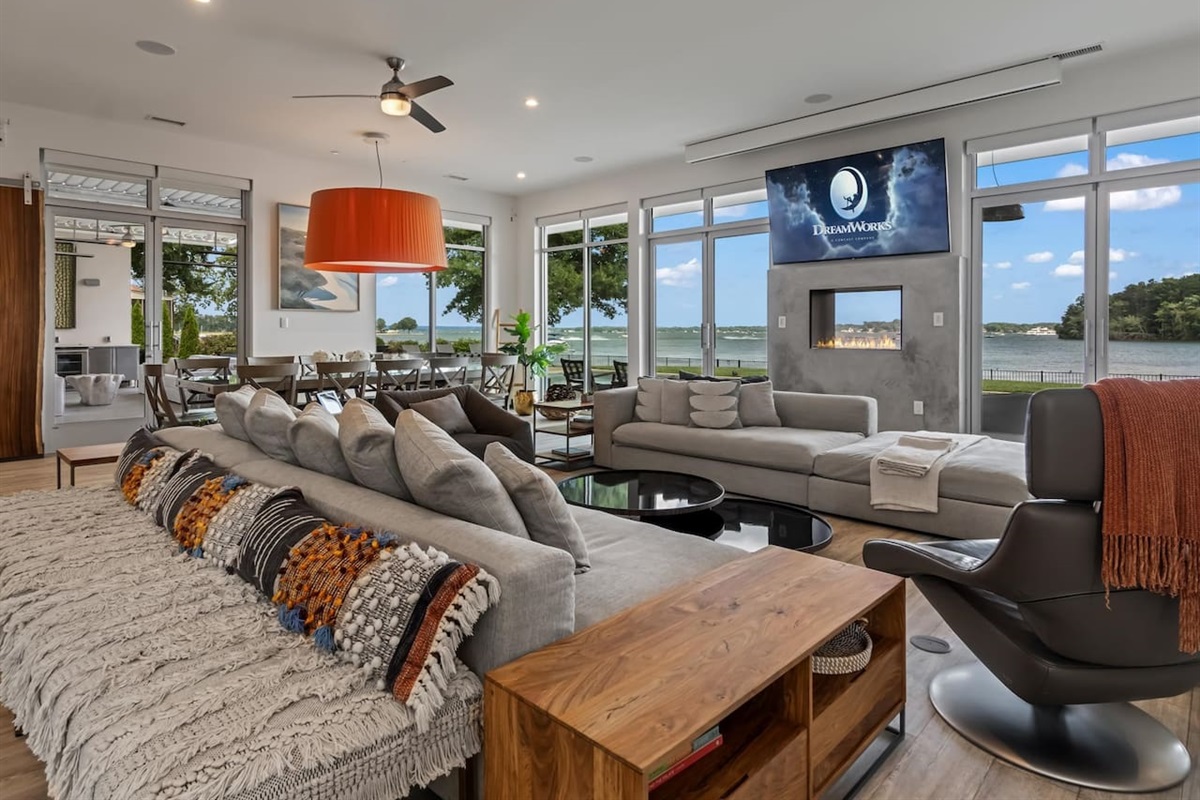 Living room with walls of glass overlooking long lake views on Lake Norman.
