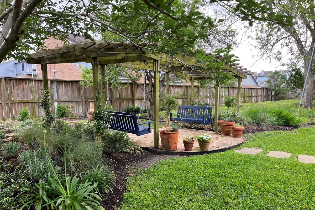 Pergola with benches and flower surrounds