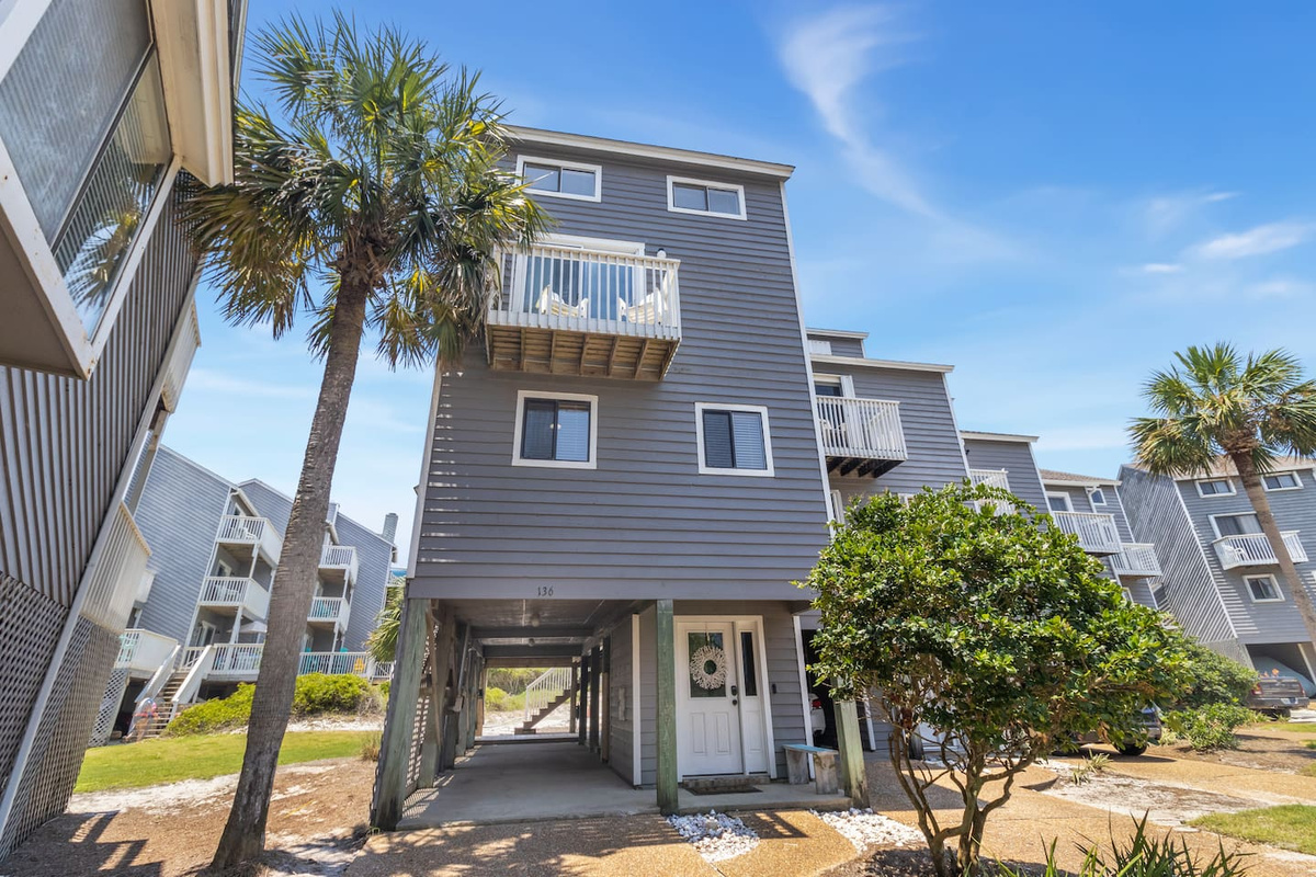 Pull up, park in the covered carport, and you're home. The beach walkover is 16 steps from this door.