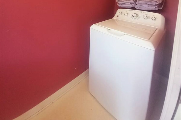 Full-sized washer and dryer in private laundry includes ironing board, drying rack and drying line, storage for cleaning supplies.  Pool towels and pool noodles stored here also!