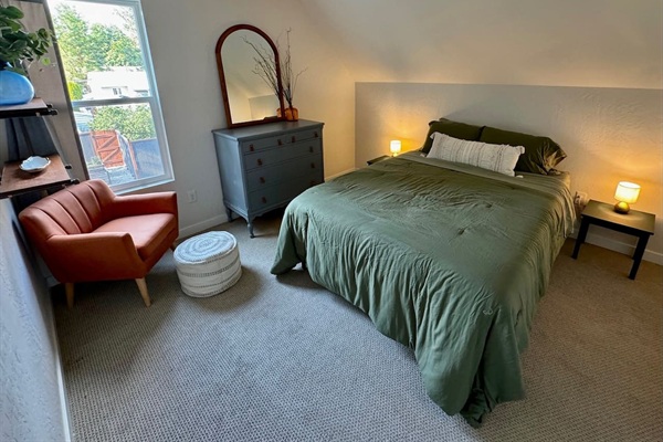 This bedroom features a queen bed, black out curtain, and a generous walk-in closet space. 