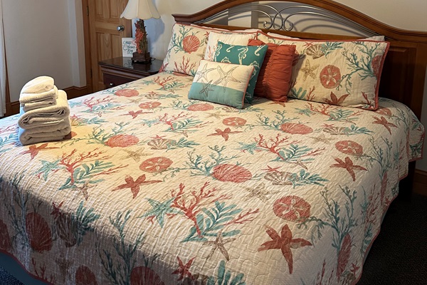 Serene King Master offering access to pool through a windowed entrance and equipped with a TV.