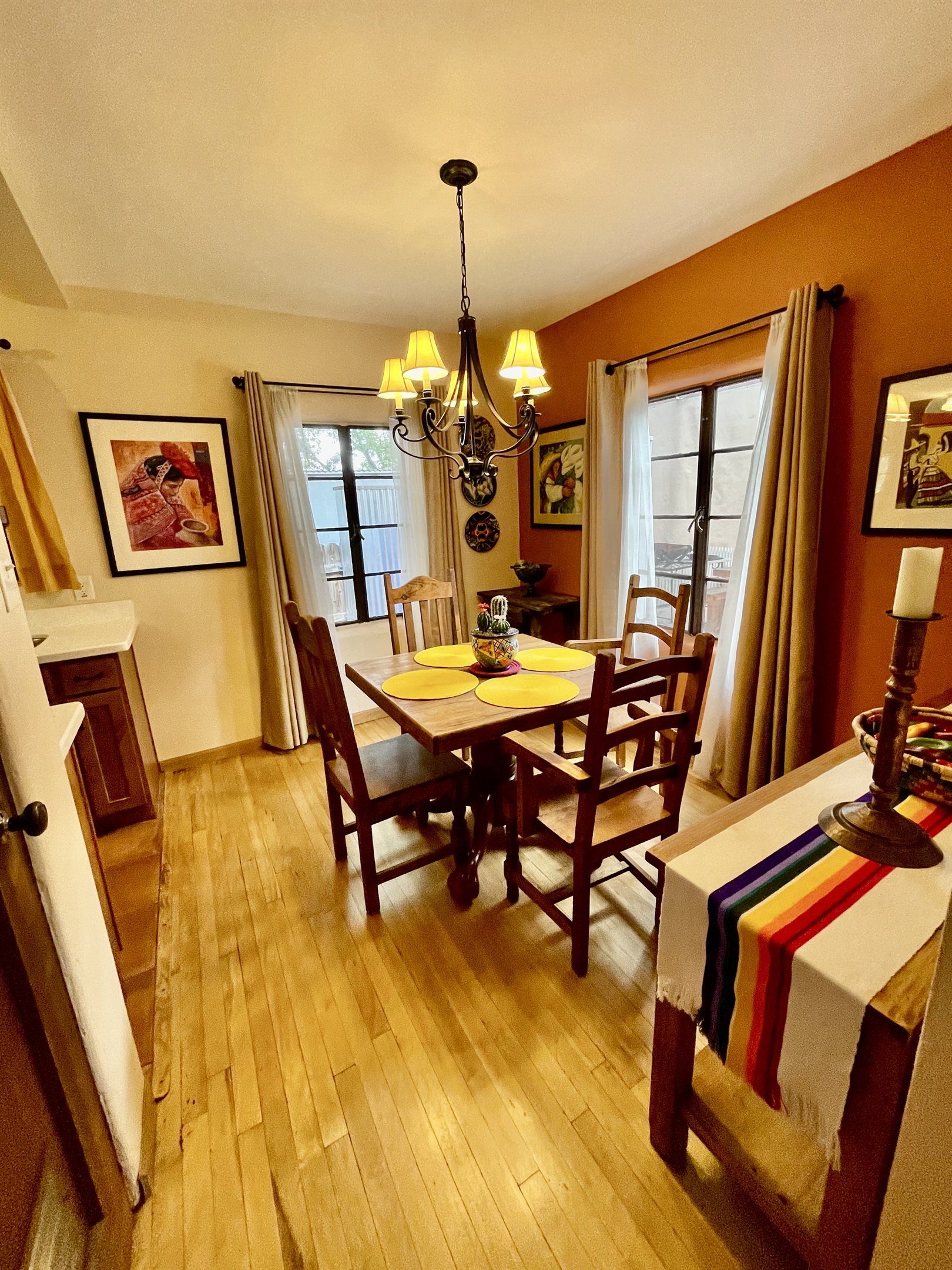 This inviting dining room features a beautiful wooden table, comfortable chairs, and warm natural light.