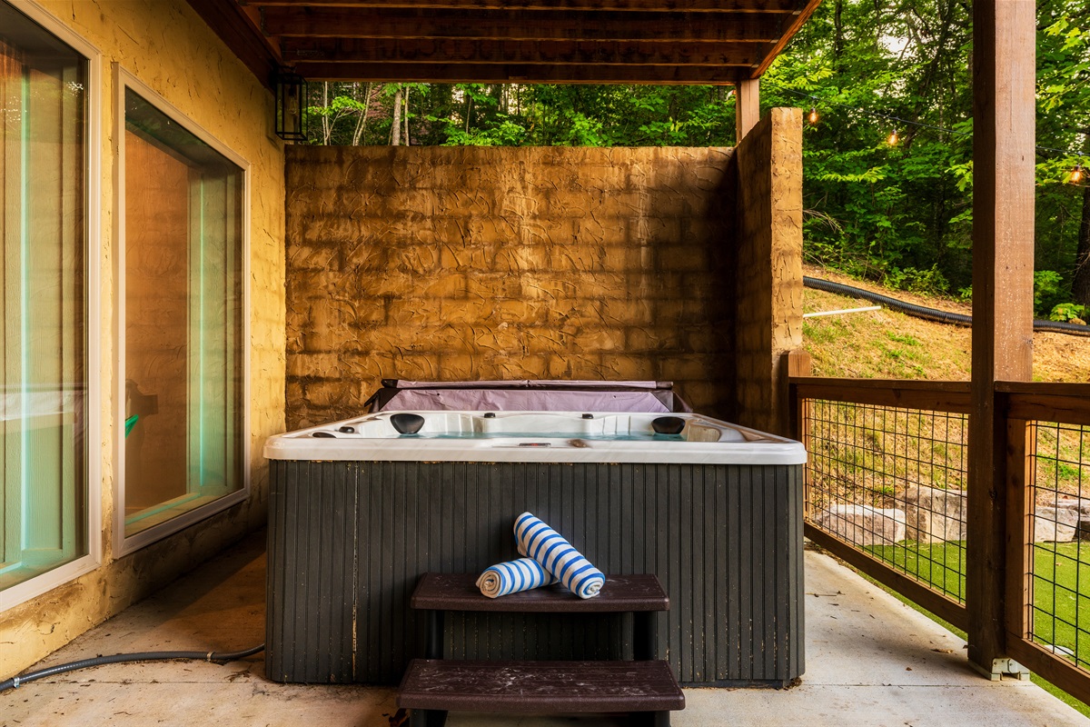 Soak in the hot tub with backyard views