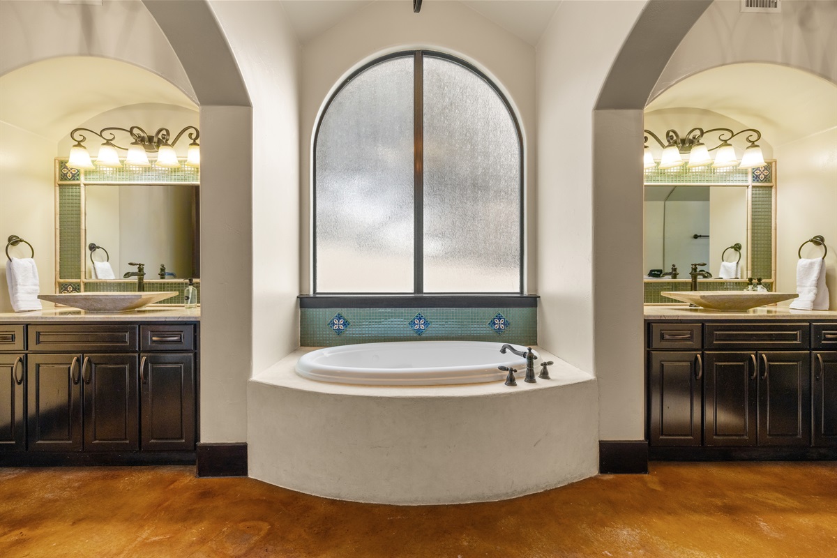 "Your private spa retreat awaits! 🛁✨ Soak in luxury in this beautifully designed master bath, featuring a serene soaking tub, dual vanities, and elegant Spanish-style details. The perfect pla