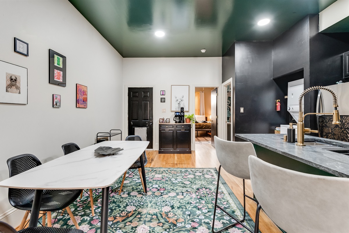 Dining Area: Brightly decorated space with sleek furniture and vibrant art for delicious gatherings!