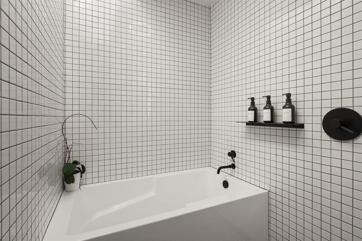 Well-appointed bathroom with a combination bathtub and walk-in shower, perfect for both a relaxing soak and a refreshing start to the day.