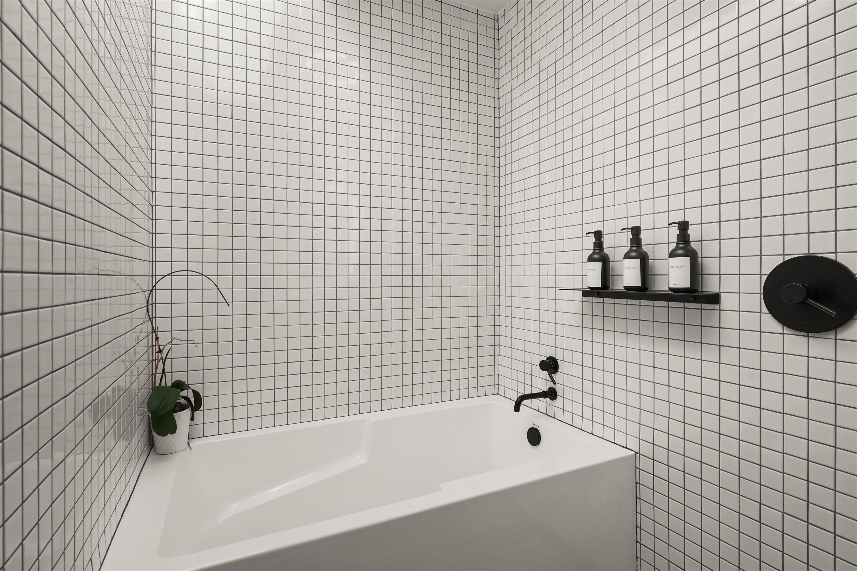 Well-appointed bathroom with a combination bathtub and walk-in shower, perfect for both a relaxing soak and a refreshing start to the day.