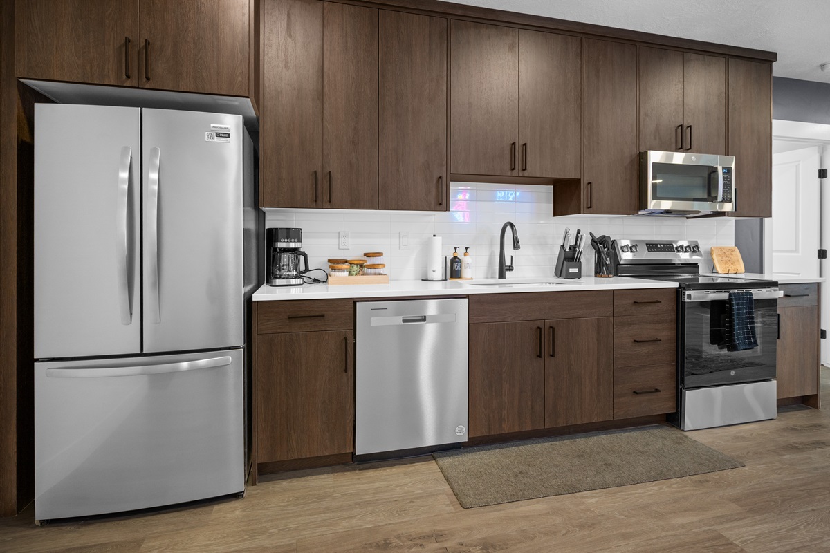 Bright, modern kitchen with quartz counters and stainless appliances