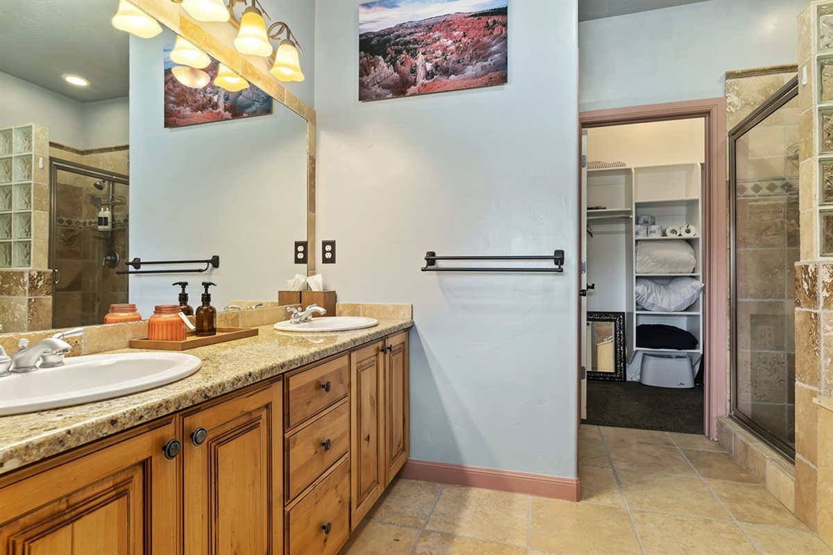 A spa-like primary bathroom with dual vanities, elegant lighting, and ample space—crafted for both relaxation and functionality.