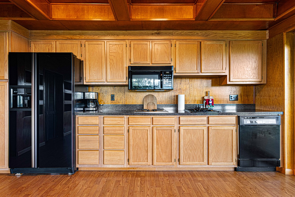 Kitchen: Modern appliances and warm wood accents await your culinary adventures!
