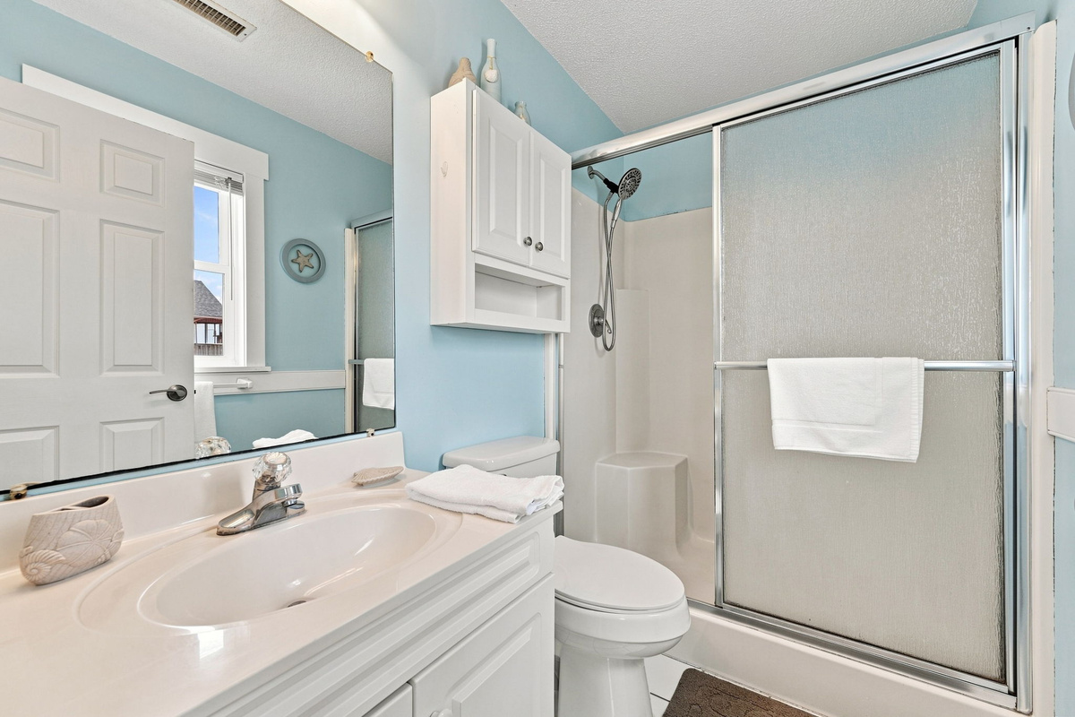 Refresh after a day at the beach in the private ensuite bathroom with a walk-in shower and fresh towels provided