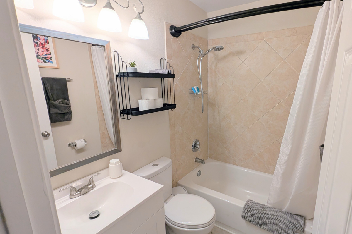 Full bathroom with tub/shower combo, water efficient toilet, fluffy towels, and fully stocked with toiletries and basic amenities. 