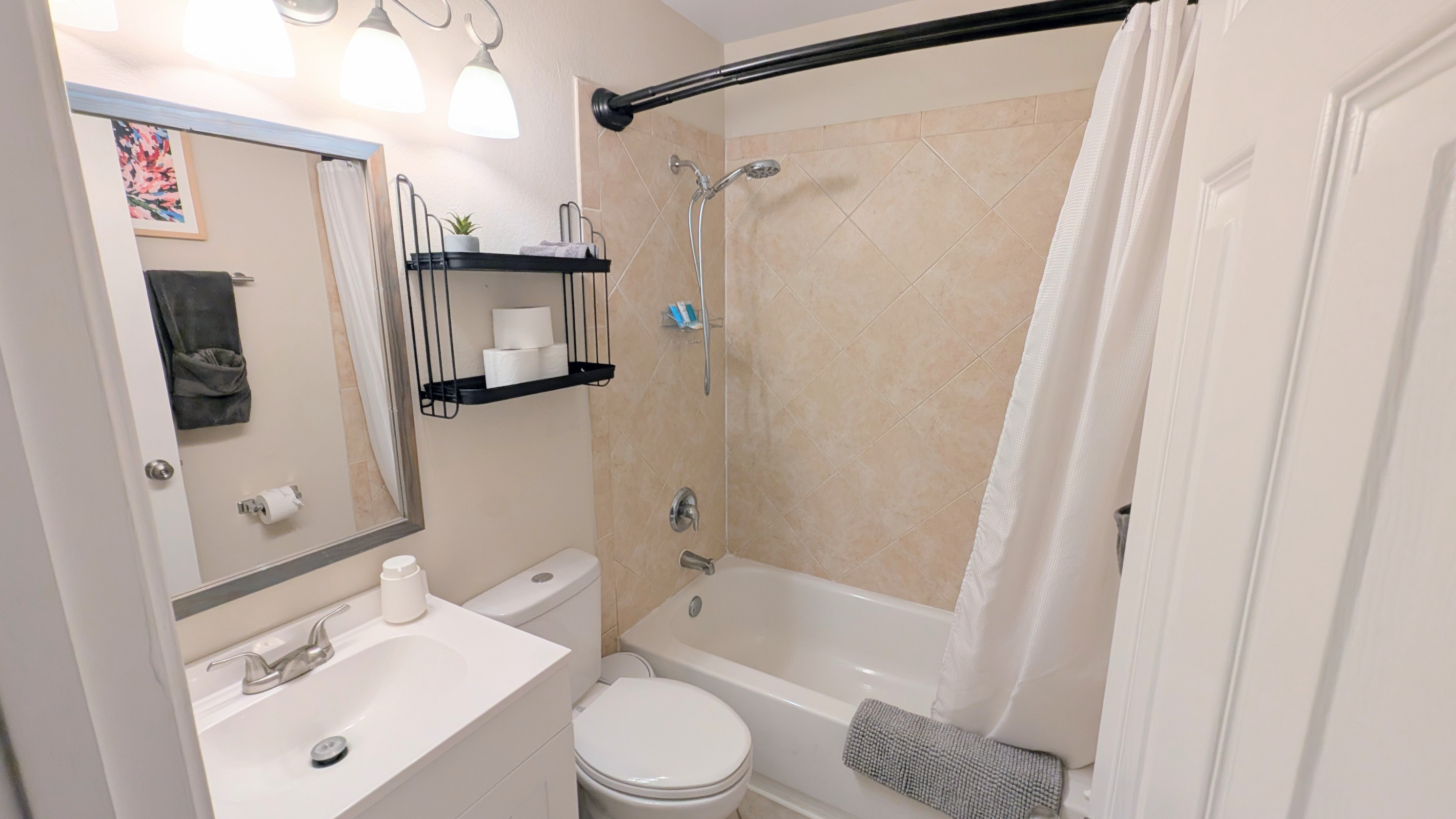 Full bathroom with tub/shower combo, water efficient toilet, fluffy towels, and fully stocked with toiletries and basic amenities. 