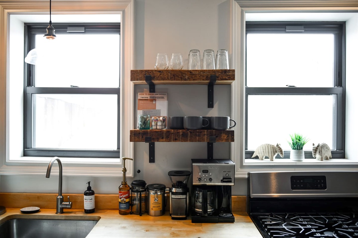 Fully equipped kitchen featuring modern design and sleek stainless steel appliances — ready for all your cooking needs.