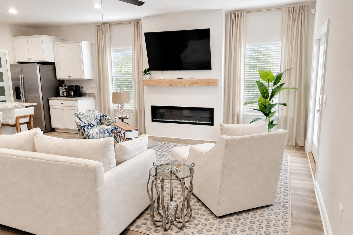 Cozy centered sleeper sofa in the heart of the open living area—extra beds + ultimate relaxation for family beach getaways.