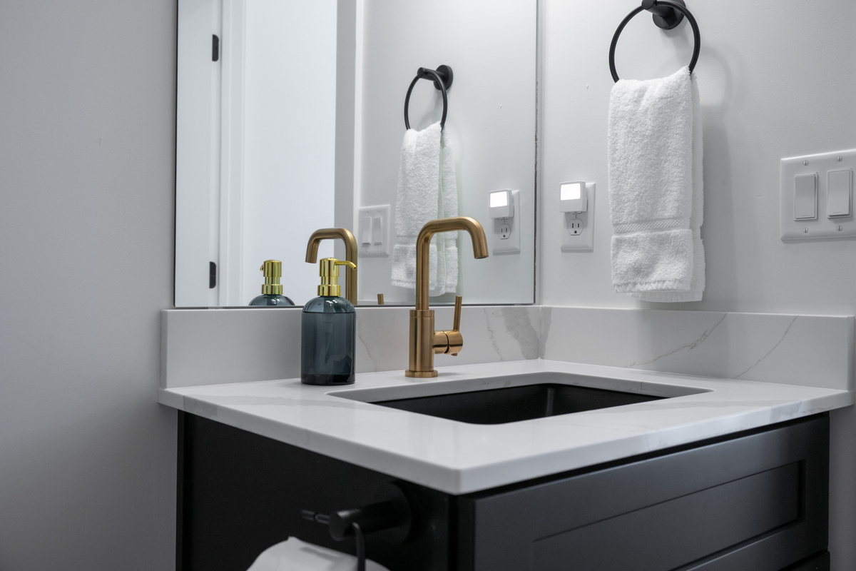 A stylish vanity area with modern fixtures and useful counter space makes daily routines easy.