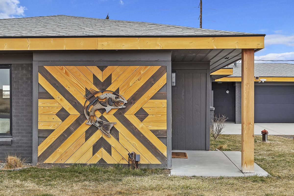 The home's welcoming front entrance and mid-century lines and custom hand crafted artwork.