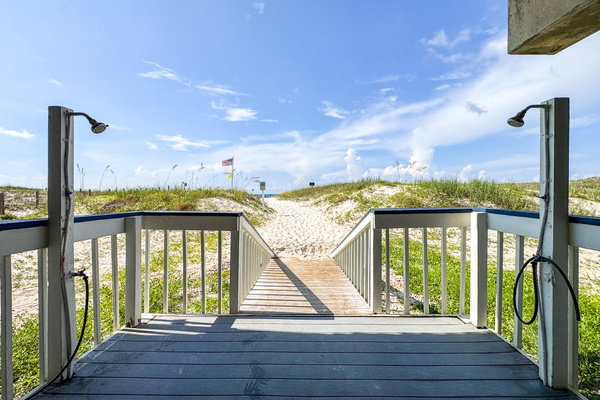 Private boardwalk with outdoor rinse showers leading straight to the beach