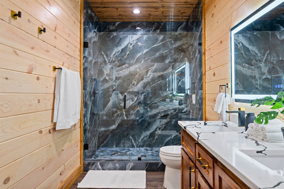 A beautifully tiled walk-in shower creates a spa-like feel in the bathroom, offering a refreshing place to start the morning or wind down in the evening.