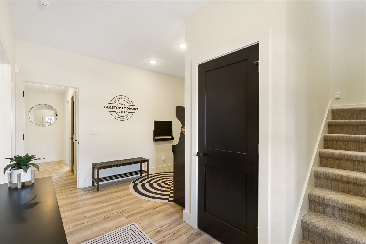 Entry level entertainment and bedrooms. Stairs lead up to the living room, kitchen, and dining plus one more bedroom.
