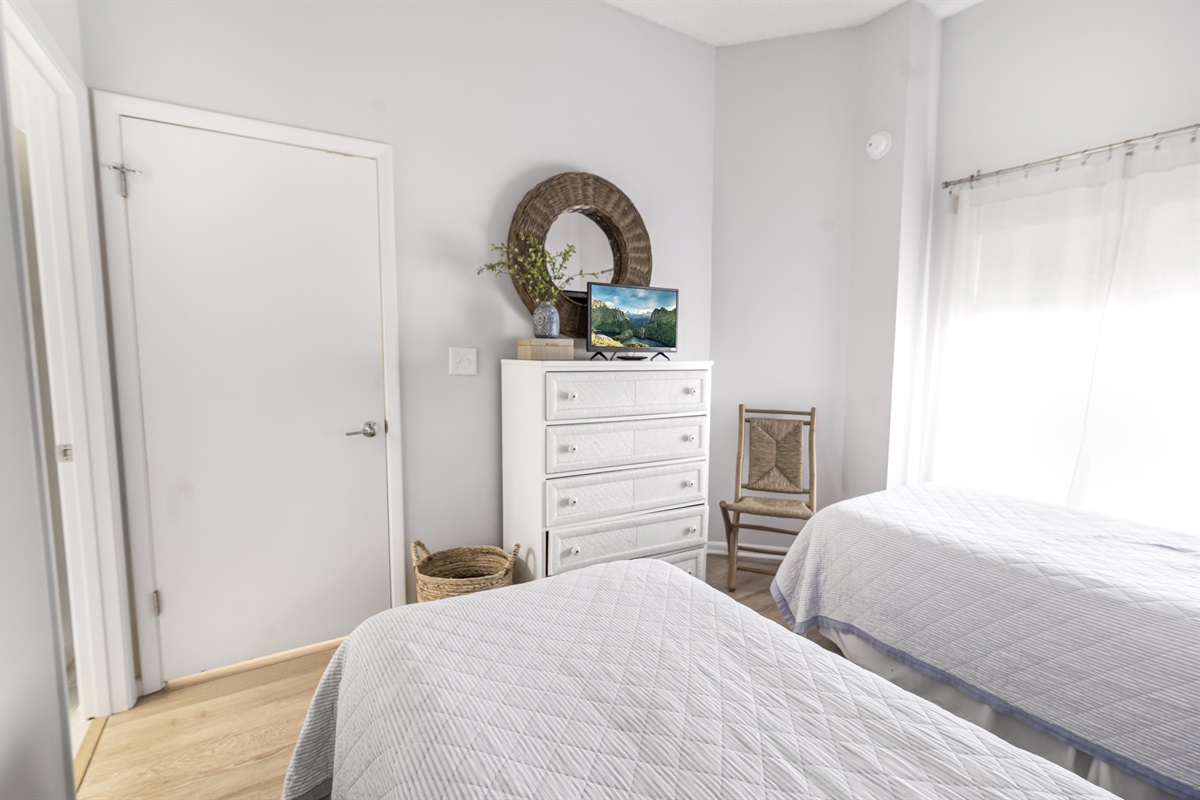 Bright and welcoming, the guest bedroom offers cozy accommodations perfect for family or friends, with easy access to a nearby full bathroom.