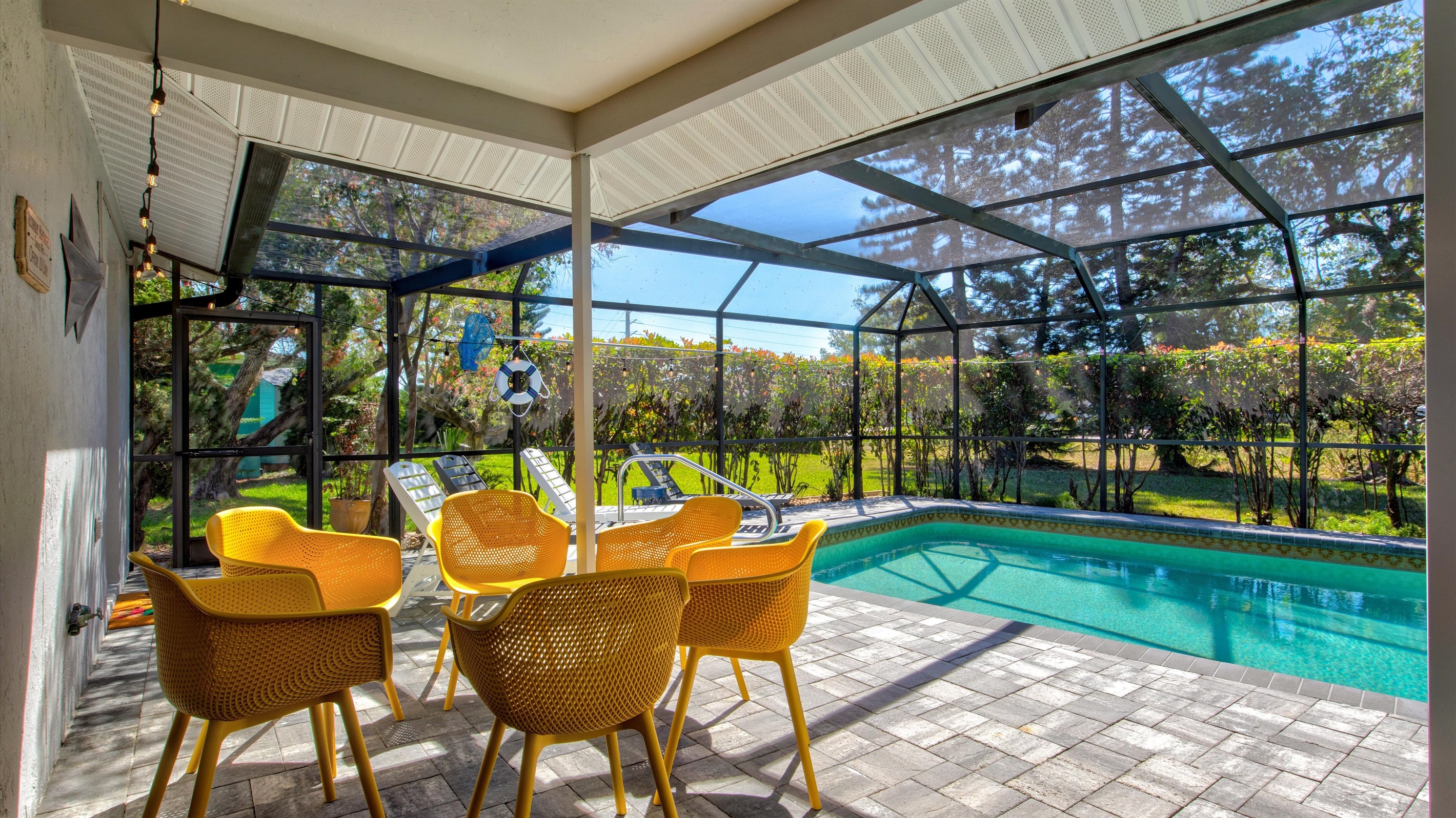 Sparkling clear waters framed by tropical plants and inviting poolside loungers.