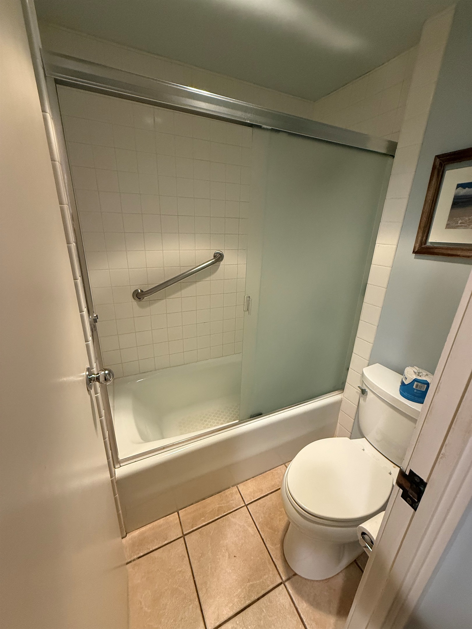 Clean bathroom with shower-tub combination