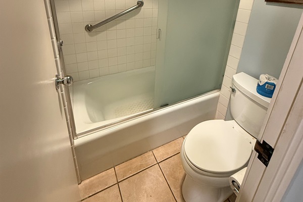 Clean bathroom with shower-tub combination