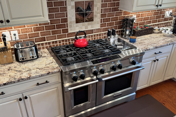 Spacious gourmet kitchen featuring a Wolf range and ample seating