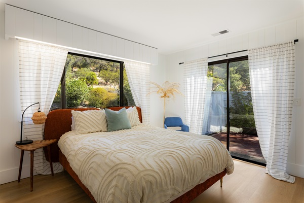 Bedroom 2 features a queen memory foam bed and a private entrance off the courtyard