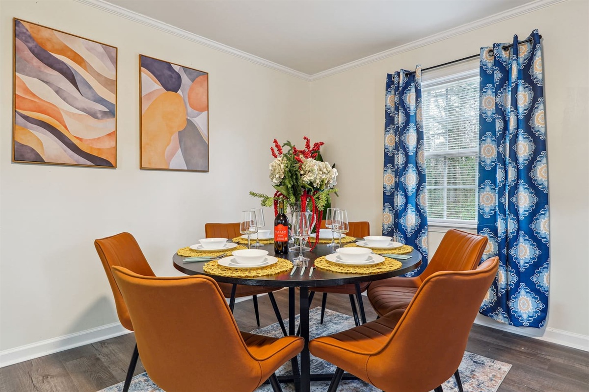 A dining area featuring a dining table set and a bar counter with four bar chairs — perfect for enjoying meals or casual drinks.
