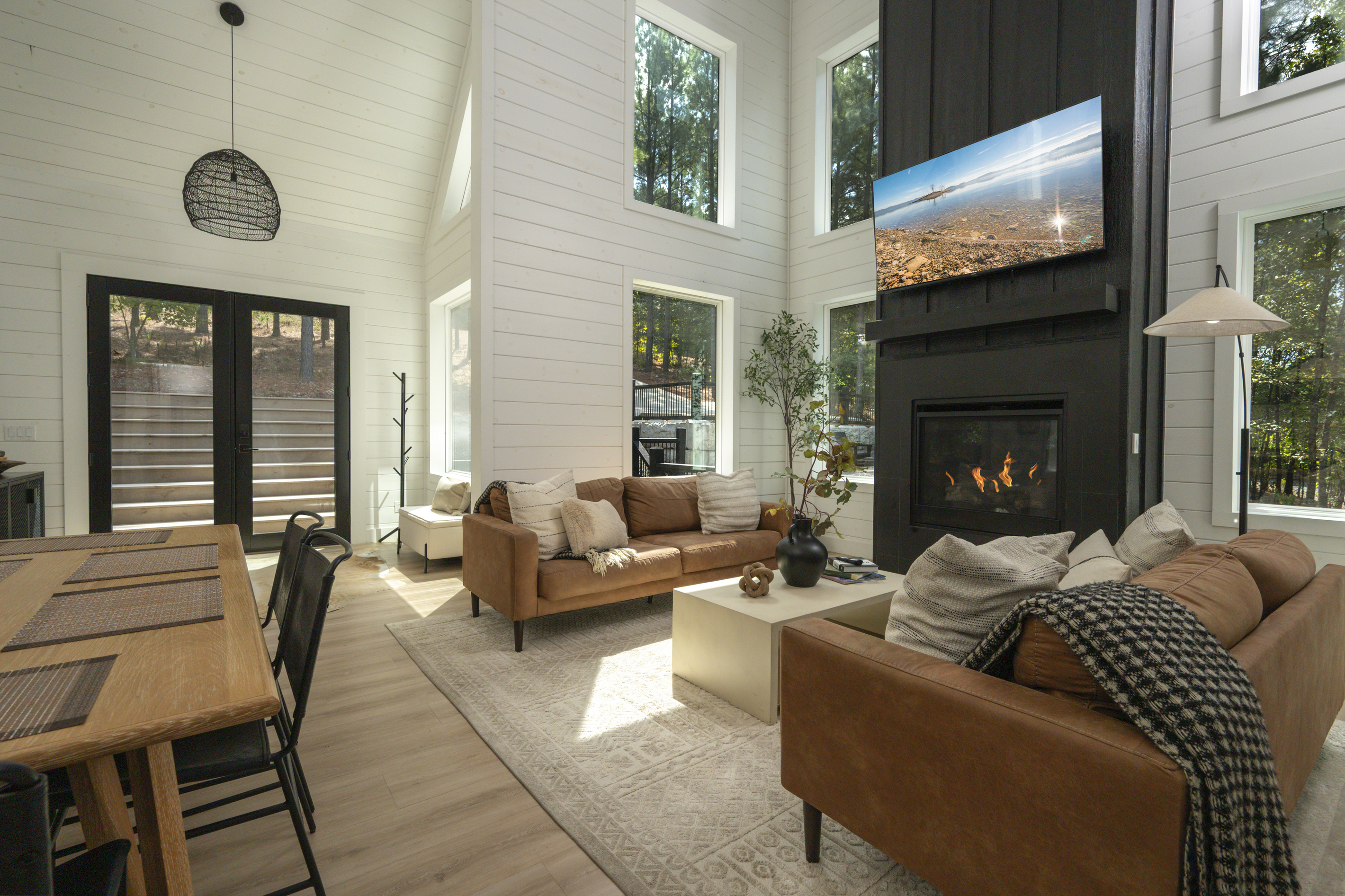 Open-concept living with cozy leather sofas, spacious dining, and a stunning kitchen.