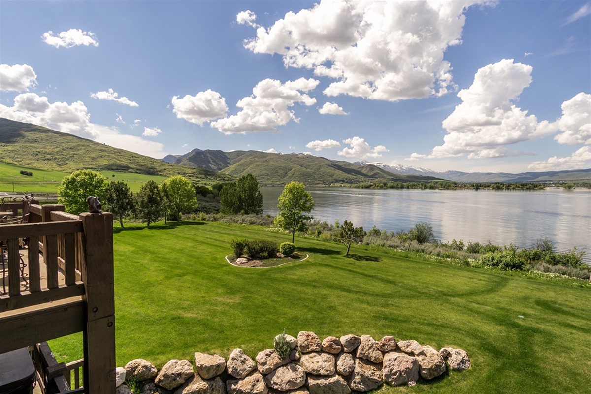 Manicured lawn rolling toward the lake creates a peaceful, open setting—perfect for quiet mornings and evening strolls.