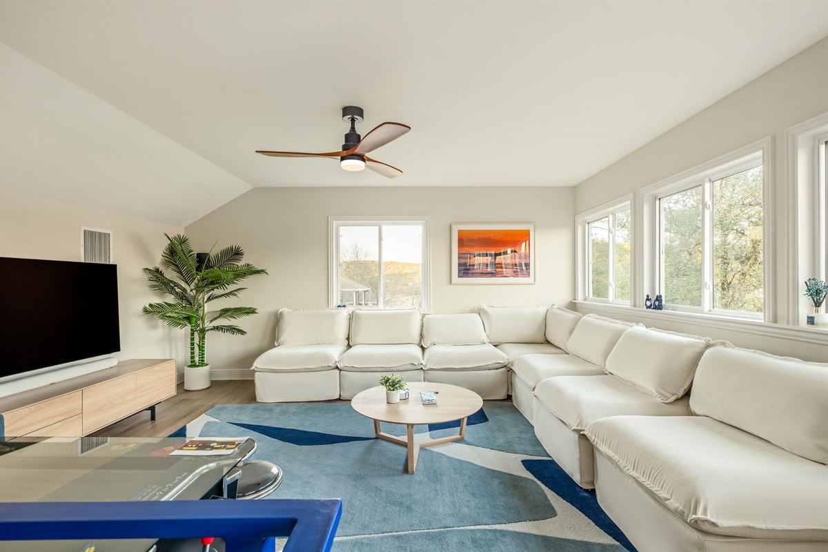 Comfortable secondary lounge space filled with natural light and cozy seating.