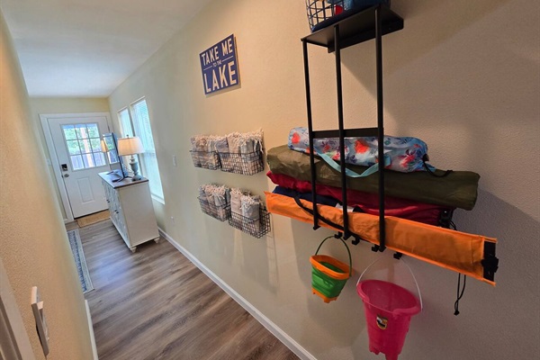 Feel free to borrow and return items along this wall, including chairs, kites, sand toys, and Turkish towels for use at the lake.